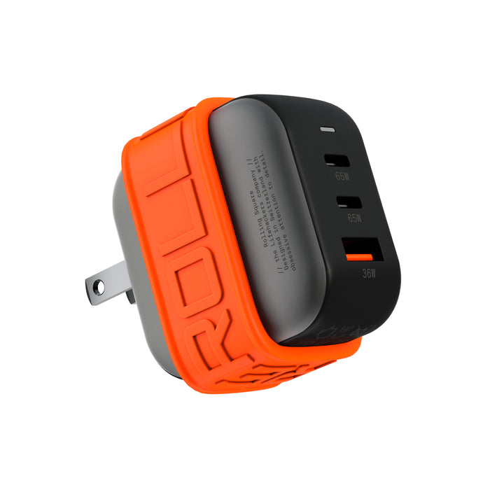 Essential GaN Charger - 65W power, 45% smaller - Essential GaN Charger - 65W power, 45% smaller - US - Compact black GaN charger with orange silicone protective sleeve and dual USB-C and one USB-A ports. - Rolling Square Essential GaN Charger - 65W power, 45% smaller - US - Compact black GaN charger with orange silicone protective sleeve and dual USB-C and one USB-A ports. - Rolling Square
