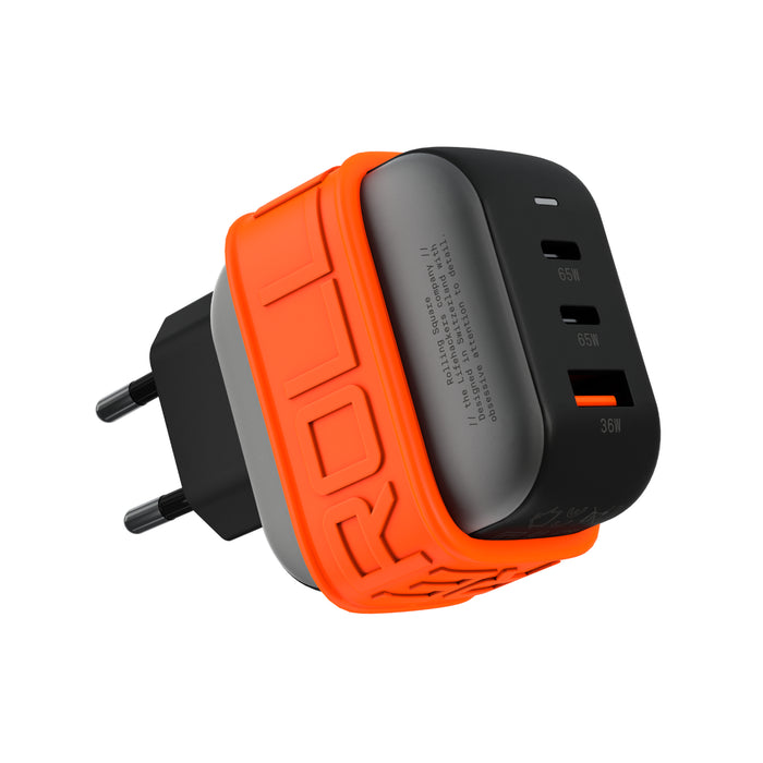 Essential GaN Charger - 65W power, 45% smaller - Essential GaN Charger - 65W power, 45% smaller - US - Black and orange 65W GaN charger with three USB ports and EU plug. - Rolling Square Essential GaN Charger - 65W power, 45% smaller - US - Black and orange 65W GaN charger with three USB ports and EU plug. - Rolling Square