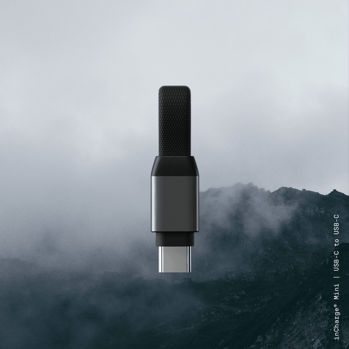 inCharge® Mini - The Smallest cable ever - inCharge® Mini - The Smallest cable ever - USB to Lightning - Compact black USB-C to USB-C charging cable with textured grip on dark foggy mountain background. - Rolling Square inCharge® Mini - The Smallest cable ever - USB to Lightning - Compact black USB-C to USB-C charging cable with textured grip on dark foggy mountain background. - Rolling Square
