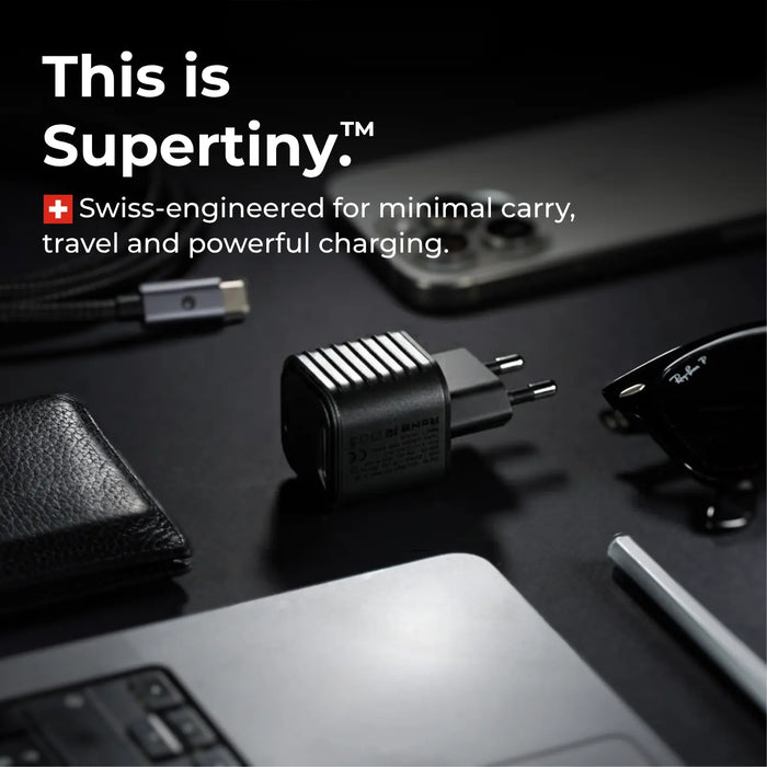 Small Swiss-engineered charging device on a dark surface with text about Supertiny and how it's portable and powerful.