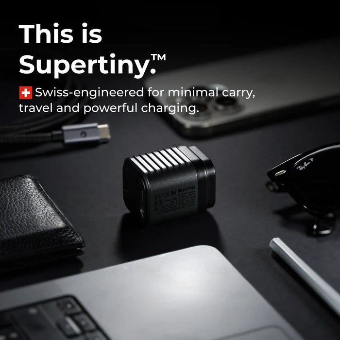 Small Swiss-engineered charging device on a dark surface with text about Supertiny and how it's portable and powerful.